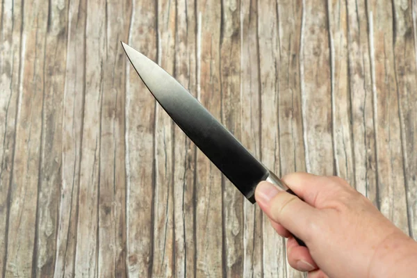 Butchers Knife Holding Hand Wooden Background — Stock Photo, Image