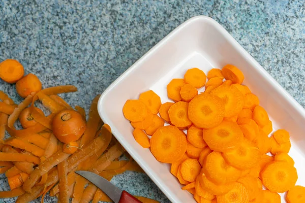 A bowl of freshly cut carrots, top view