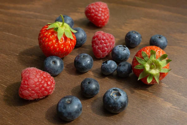 Fresas Frambuesas Arándanos Yacen Sobre Una Mesa Madera — Foto de Stock