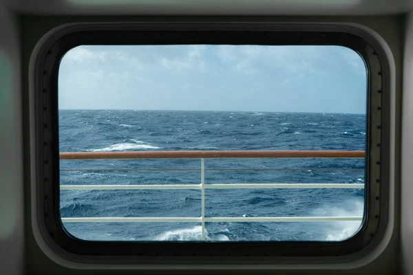 View from a cabin window of a cruise ship on the stormy sea