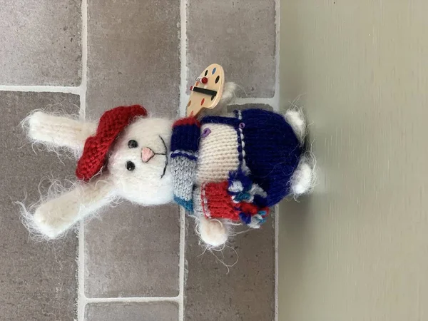 Cute hand made hare or rabbit artist toy knitted with paints and scarf — Stock Photo, Image