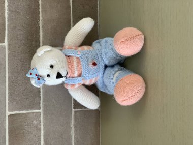 Örme şirin oyuncak ayı oyuncak masada oturan kostüm.