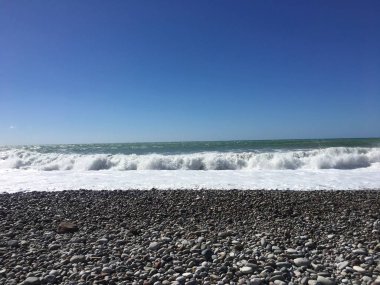 Dalgalar Breaking ve Püskürtme High Seas ve Güçlü Rüzgarlar wth güneş.