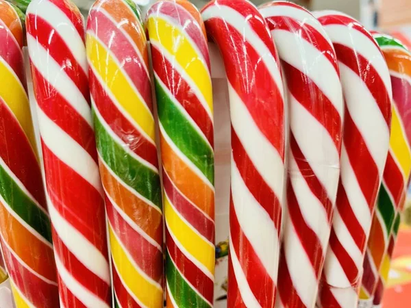 colorful candy canes in bucket in the shop.
