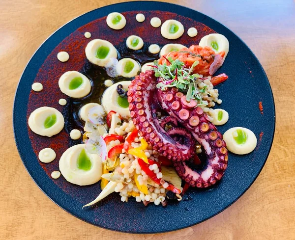 close up of grilled cooked octopus on plate