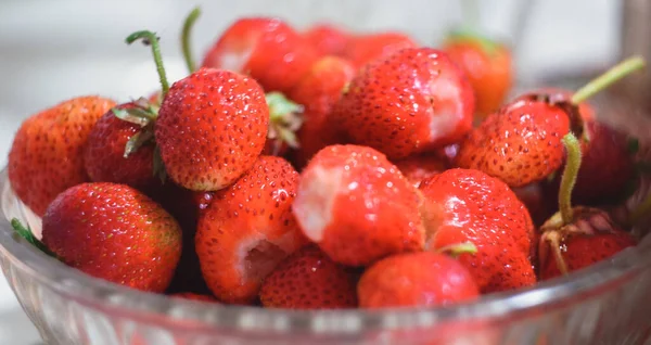 Red ripe strawberry apples close-up. Red ripe strawberries in a cup