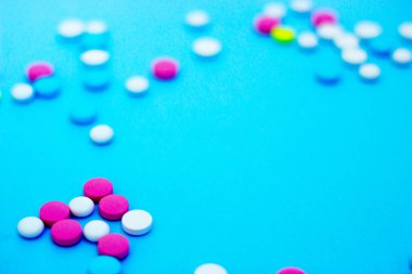 Kopyalama alanı ile mavi arka plan üzerinde çok renkli haplar.