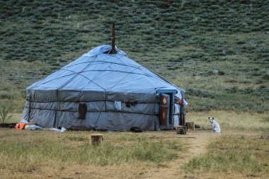 The traditional house is a yurt of Tuva and Mongol nomads. The dog is guarding the house clipart