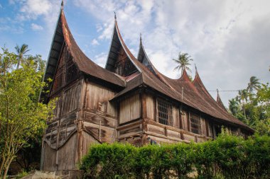 Sumatra, Endonezya 'daki Minangkabau köyünde alışılmadık bir çatısı olan ahşap bir kır evi..
