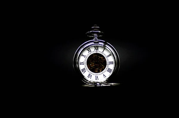 Time is running out, pocket watch on a black background
