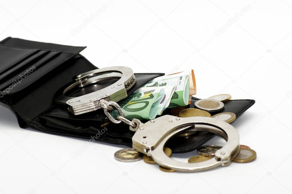 Criminal money transactions euro banknotes and handcuffs                   