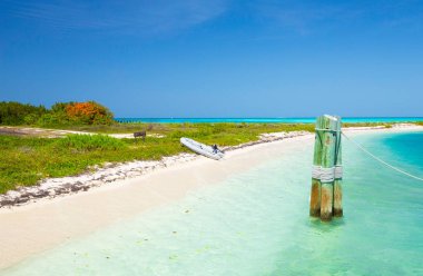 boats near beach and Civil War Fort Jefferson in Dry Tortugas National Park, Florida, USA clipart