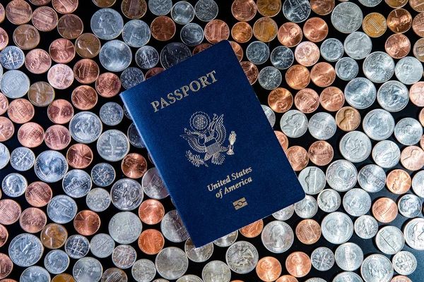 american passport on golden and silver american dollar coins