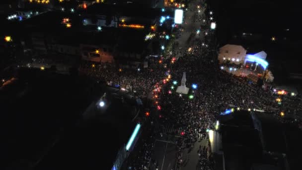 Aerial footage slow tilting up new year night view of people crowd with beautiful light star around Yogyakarta monument intersection, its called TUGU JOGJA — Stock Video
