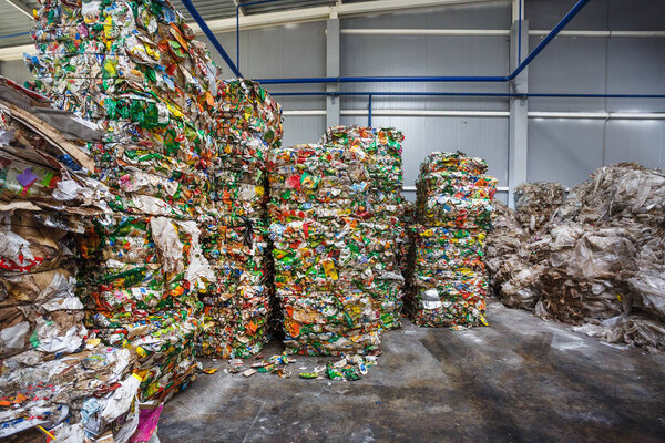 Plastic pressed polyethylene bales at finished products warehouse on modern waste hazardous processing plant. Separate garbage collection. Recycling and storage of waste for further disposal. 
