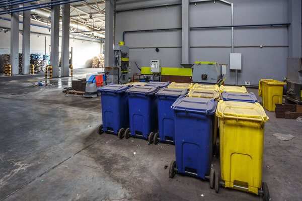 Containers with used bottles and  plastic bales of rubbish at waste treatment processing plant. Recycling separatee and storage of garbage for further disposal, trash sorting. 