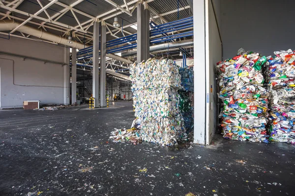 Plastic bales of rubbish at the waste treatment processing plant. Recycling separatee and storage of garbage for further disposal, trash sorting. Business for sorting and processing of waste.