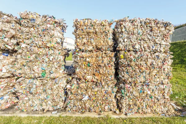 Plastic bales of rubbish at the waste treatment processing plant. Recycling separatee and storage of garbage for further disposal, trash sorting. Business for sorting and processing of waste.