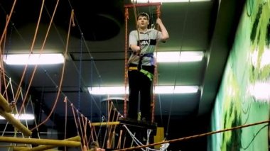 Grodno, Belarus - Ocak 2019: şişko bir çocuk eğlence merkezi modern orman parkının günlüklerinde bir engel ders üstesinden gelir