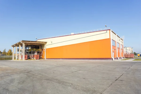 manufacture building of modern waste recycling processing plant in orange style. Separate garbage collection. Recycling and storage of waste for further disposal.