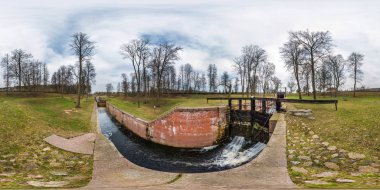 panorama 360 angle view near gateway lock sluice construction on river, canal for passing vessels at different water levels. Full spherical seamless 360 degrees  panorama in equirectangular projection clipart