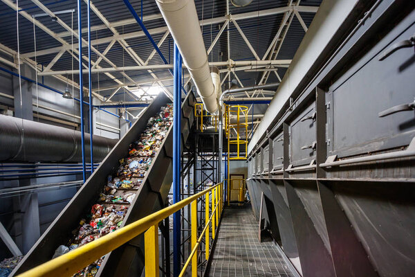 moving conveyor transporter on Modern waste recycling processing plant. Separate and sorting garbage collection. Recycling and storage of waste for further disposal. 