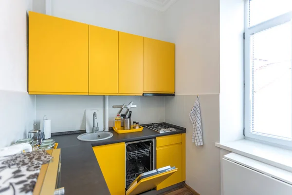 MINSK, BELARUS - JANUARY, 2019: Interior of the modern kitchen in loft flat apartment in minimalistic style with yellow color