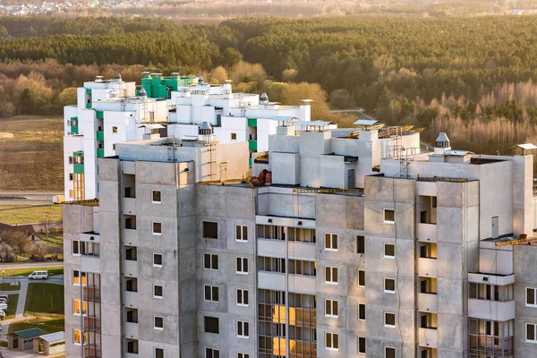 Панорамный вид на строительство незавершенного многоэтажного здания с высоты птичьего полета с лесом на заднем плане — стоковое фото