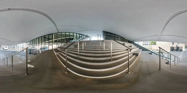 VILNIUS, LITHUANIA - MAY, 2019: Panorama esférico completo sin costuras ángulo de 360 grados cerca de la fachada del edificio moderno torcido con vidrio espejo enorme con escaleras en proyección equirectangular, contenido de realidad virtual —  Fotos de Stock