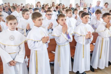 Grodno, Beyaz Rusya - Mayıs 2019: Katolik Kilisesi'ndeki küçük çocuklar ilk eucharist komünyonu bekliyor. Beyaz elbiseli küçük melekler