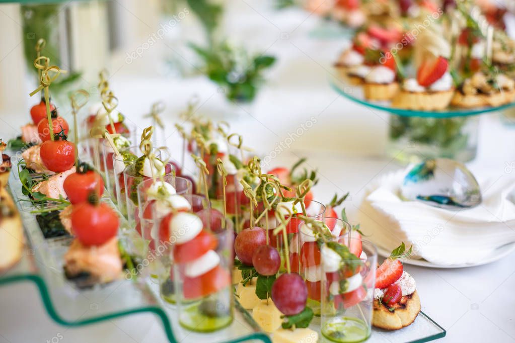 Catering. Off-site food. Buffet table with various canapes, sandwiches, hamburgers and snacks. 