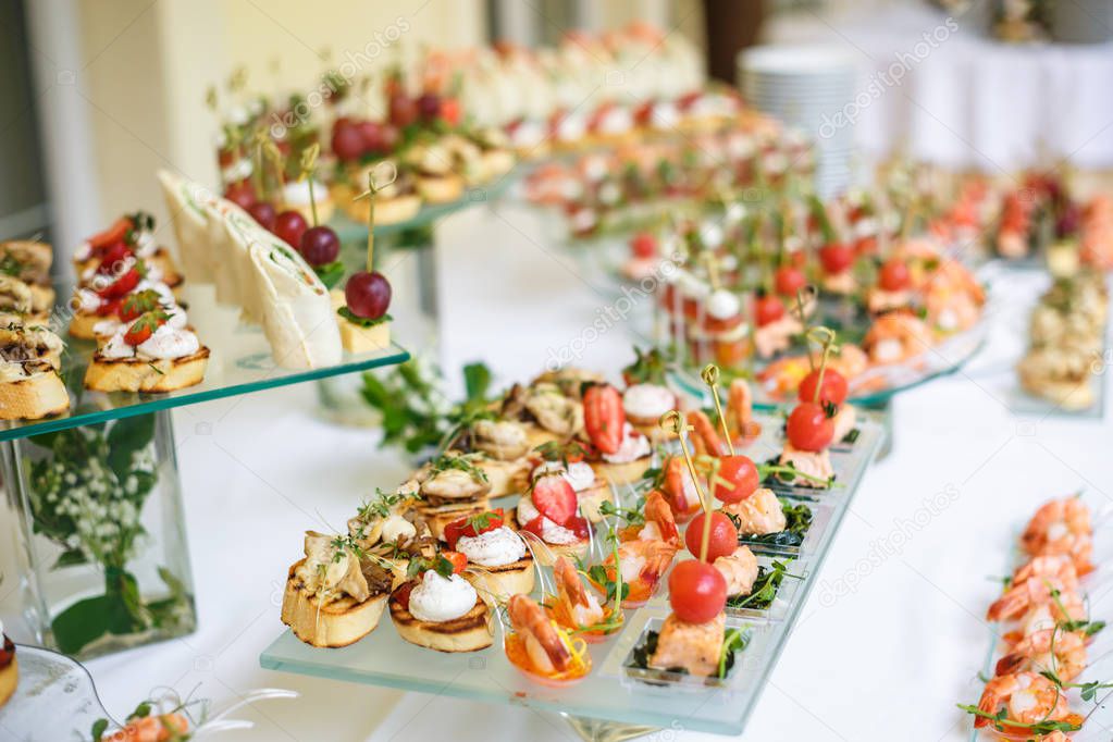 Catering. Off-site food. Buffet table with various canapes, sandwiches, hamburgers and snacks. 