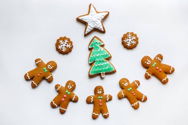 Yıldız şeklinde el yapımı şenlikli zencefilli kurabiye, kar taneleri, insanlar, çorap, personel, eldivenler, Noel ağaçları, xmas ve beyaz kağıt arka plan üzerinde yeni yıl tatili için kalpler
