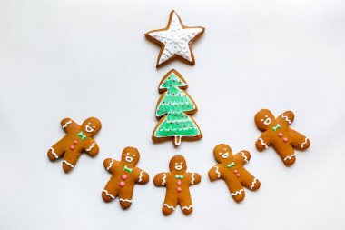 Yıldız şeklinde el yapımı şenlikli zencefilli kurabiye, kar taneleri, insanlar, çorap, personel, eldivenler, Noel ağaçları, xmas ve beyaz kağıt arka plan üzerinde yeni yıl tatili için kalpler