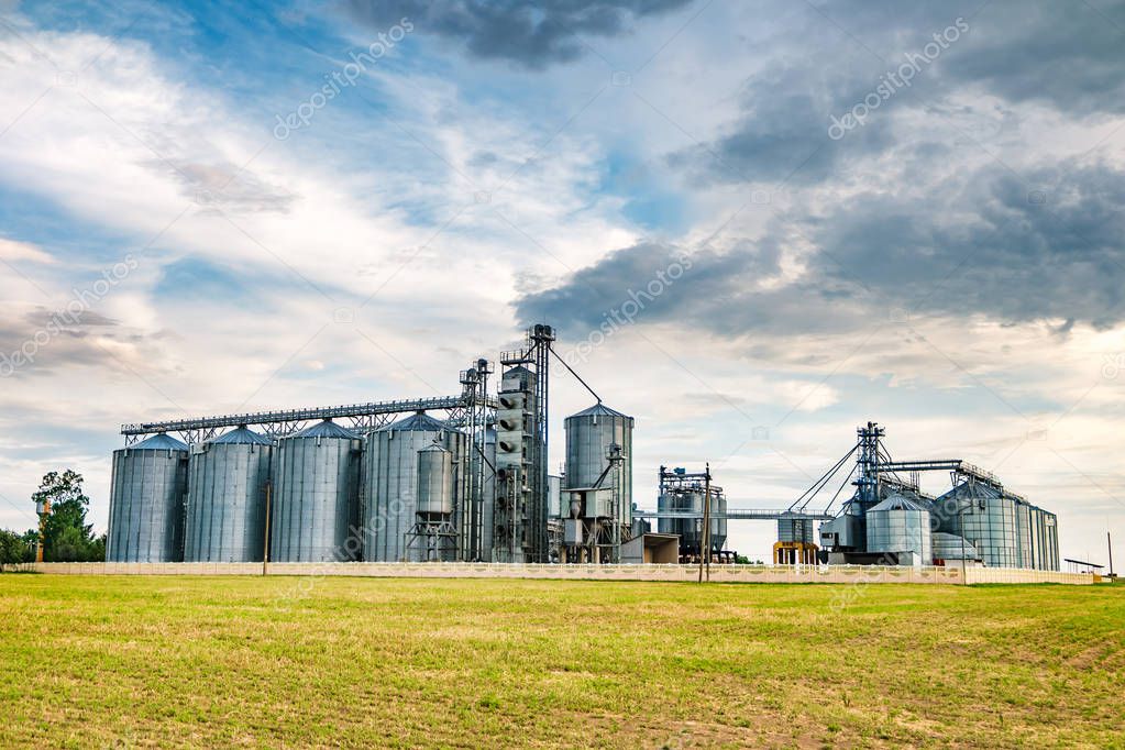 agro-processing plant for processing and silos for drying cleaning and storage of agricultural products, flour, cereals and grain with beautiful clouds