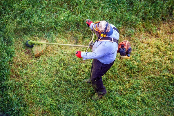 Top view lawnmover man worker cutting dry grass with lawn mower. — Stock Photo, Image