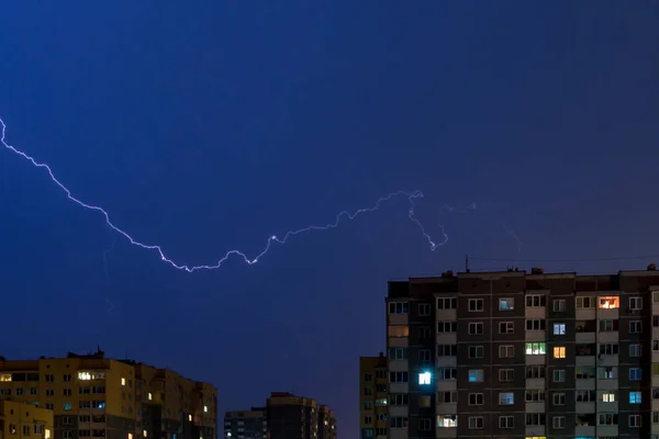 Thunderstorm with Lightning bolt strike over city. Moment lightn