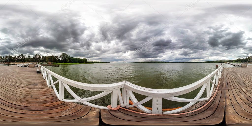 full seamless spherical hdri panorama 360 degrees  angle view on wooden pier for ships on huge lake in gray rain sky in equirectangular projection, VR AR content. 