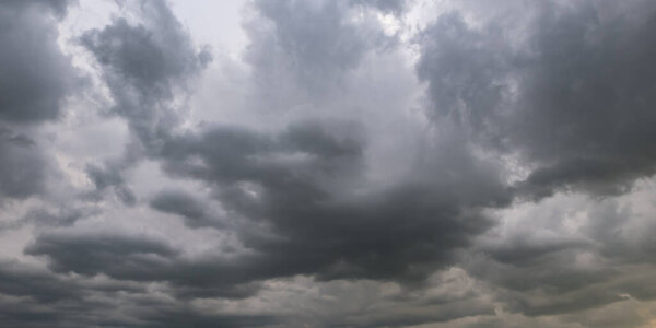 panorama of black sky background with storm clouds. thunder front