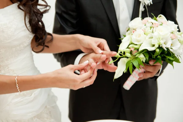 新郎用结婚花束拥抱新娘 新婚夫妇手上的戒指 新娘把手放在新郎的肩上 — 图库照片