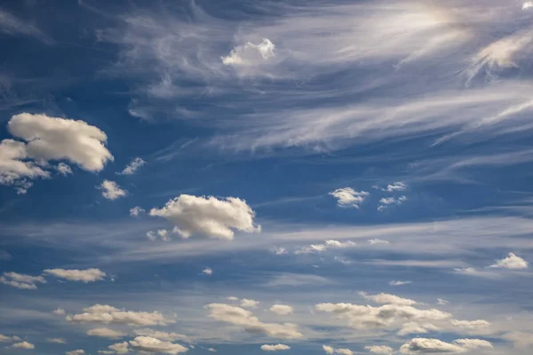 Blue sky background with white striped clouds. Clearing day and Good windy weather