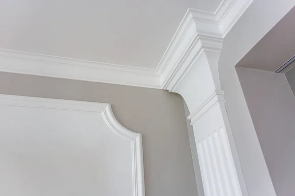 Detail of corner ceiling with intricate crown molding.