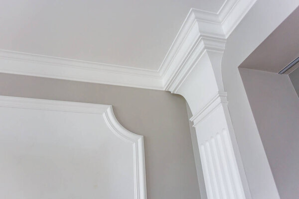 Detail of corner ceiling with intricate crown molding. 