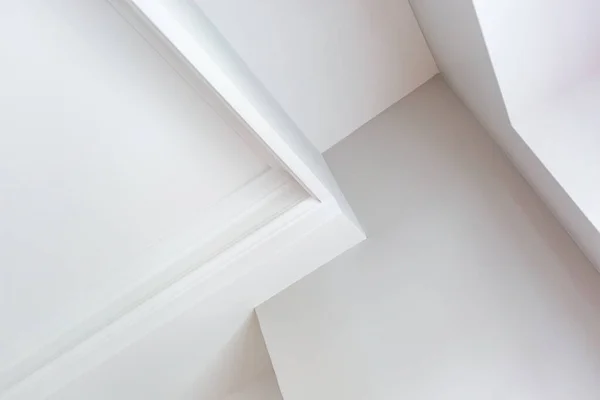 Detail of corner ceiling with intricate crown molding.