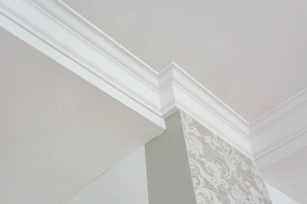 Detail of corner ceiling with intricate crown molding. 