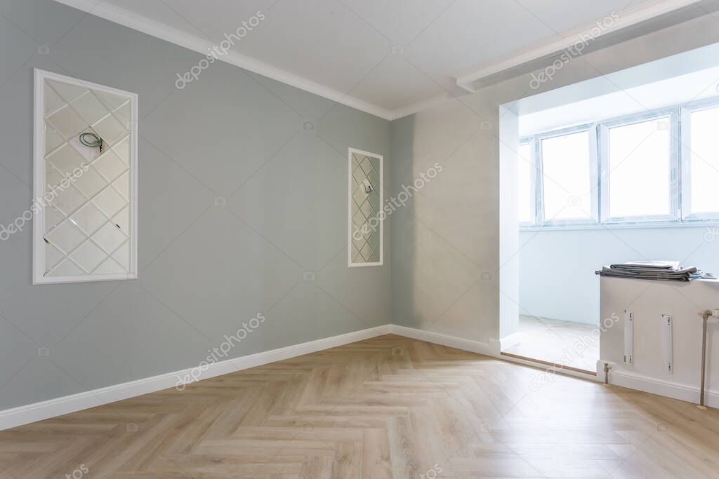 Empty unfurnished room with minimal preparatory repairs with crown molding. interior of white and gray walls