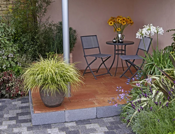 Containers of Carex grasses on a patio in a contemporary garden