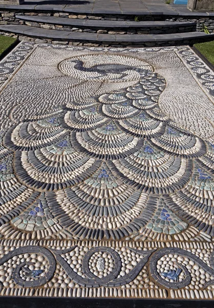 A good example of a traditional Peacock design in pebble mosaic in a garden terrace