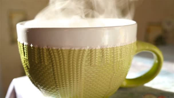 A large cup of tea is on the table. Transparent steam. Slow Motion — Stock Video