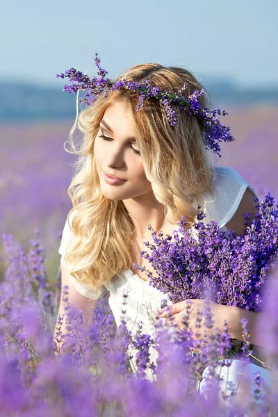 Beautiful Young woman posing in the lavender field.